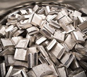 A pile of metal cubes in a bowl.