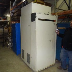 A man standing next to an old refrigerator.