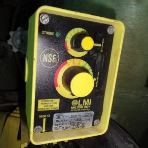 A yellow control box with two buttons and a red button.