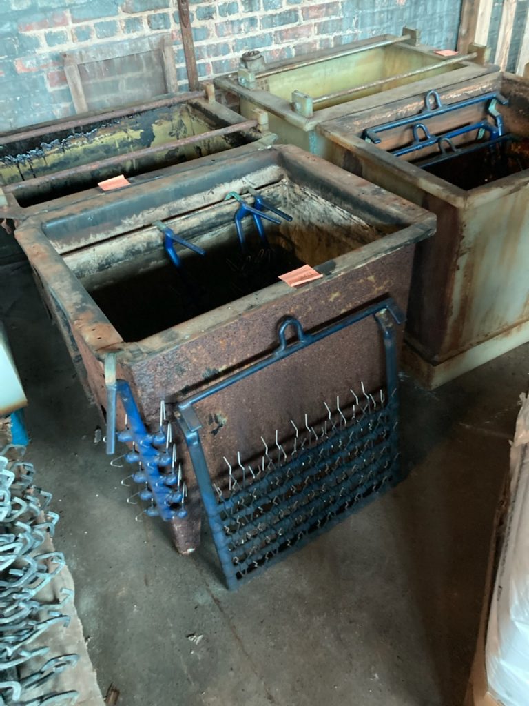 A bunch of old rusty boxes sitting on the floor