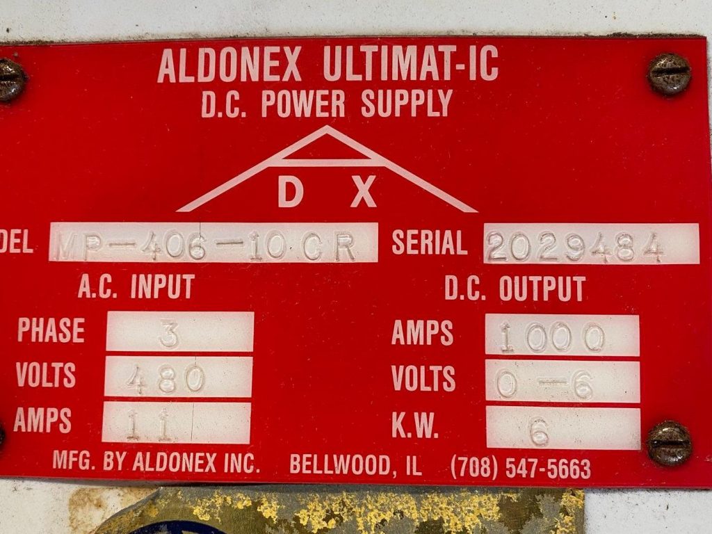 A red sign with the numbers d x and serial number.