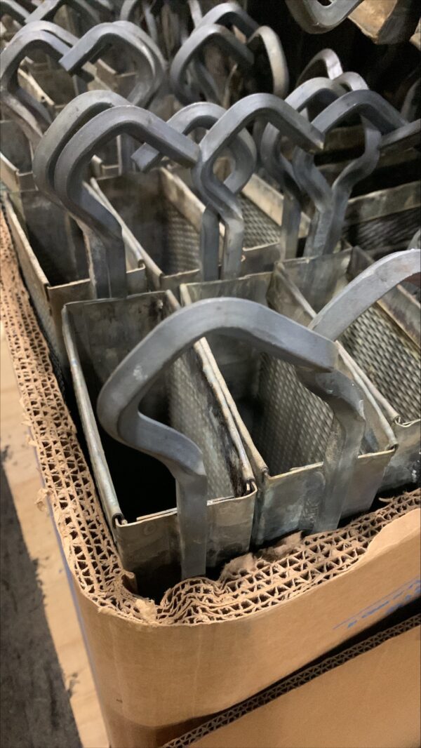 A metal basket with handles in it.